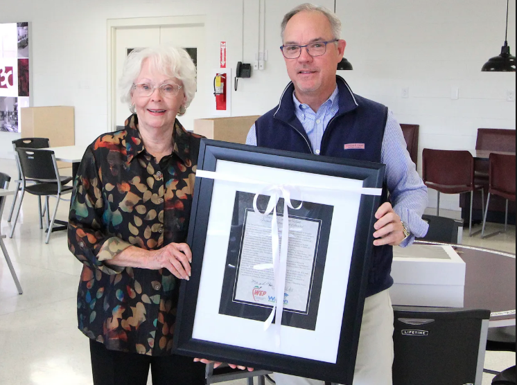 Carolyn Daniel and Michael Jones of 3C Store Fixtures, hold the framed Hunt Award